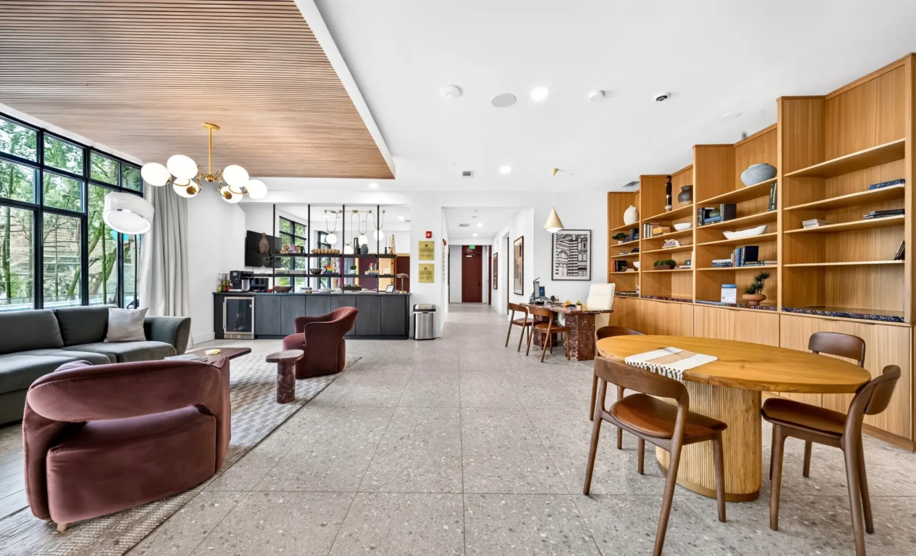 Renovated multifamily leasing lounge with custom millwork and resident seating