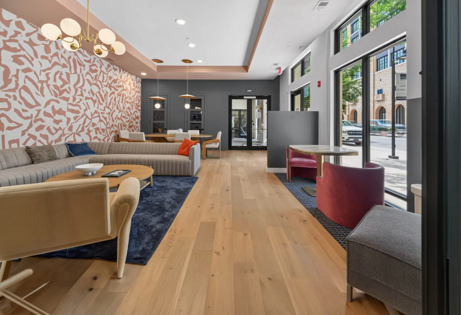 Renovated multifamily resident lounge with new flooring, lighting, finishes, and furniture