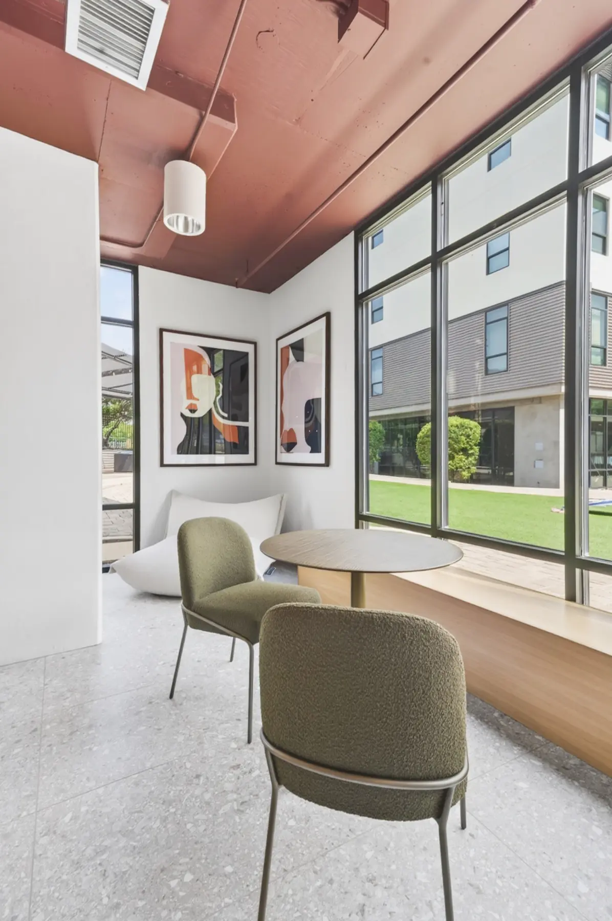Renovated resident common area with architectural windows and built-in seating