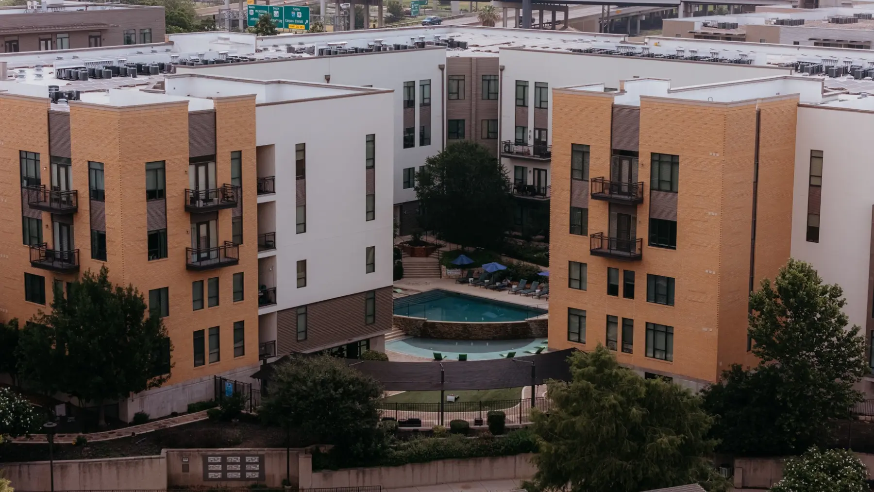 Multifamily property exterior and pool courtyard after improvements