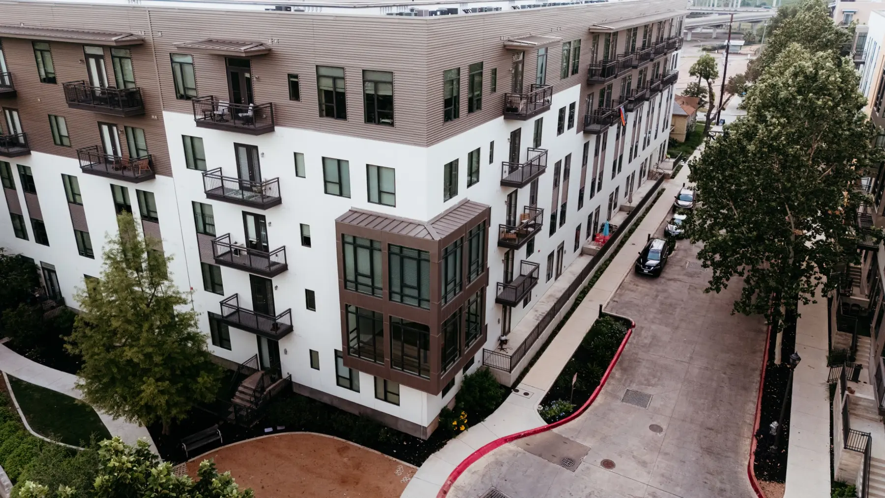 Renovated multifamily building facade with balconies and updated exterior finishes